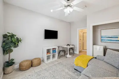 a living room with a couch and a tv at Tram-on-Time Carriage House by 30A Escapes in Rosemary Beach