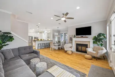 a living room with a couch and a fireplace at Tram-on-Time Main House by 30A Escapes in Rosemary Beach