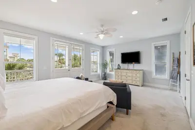 a large bedroom with a large bed and windows at Tram-on-Time Main House by 30A Escapes in Rosemary Beach