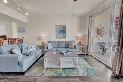 a living room with a couch and a table at Blue Skies at Shores in Panama City Beach