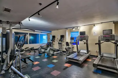 a gym with several treadmills and elliptical machines at Blue Skies at Shores in Panama City Beach