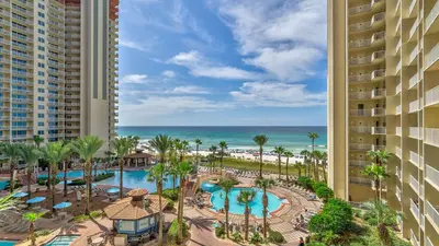 an aerial view of a resort with a swimming pool and the ocean at Blue Skies at Shores in Panama City Beach