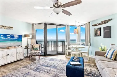 a living room with a couch and a ceiling fan at Perching Pretty at Sunbird in Panama City Beach