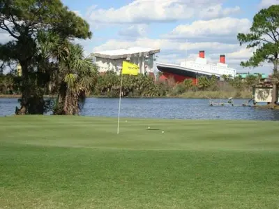 a golf course with a flag in the middle of a lake at Sea Turtle at Laketown Wharf in Panama City Beach