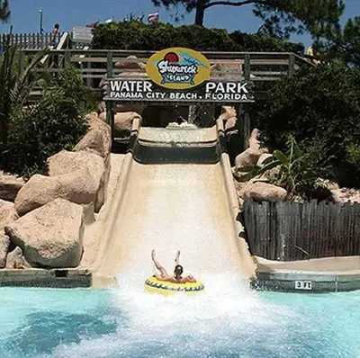 a person riding a water slide at a theme park at Sea Turtle at Laketown Wharf in Panama City Beach