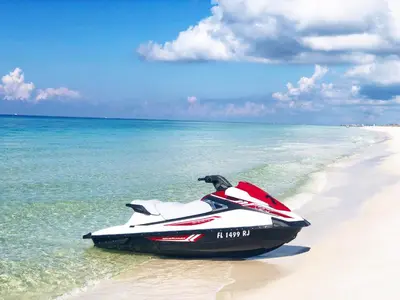 a jet ski sitting on a beach next to the ocean at Sea Turtle at Laketown Wharf in Panama City Beach