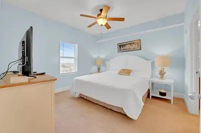 a bedroom with a bed and a flat screen tv at Sea Turtle at Laketown Wharf in Panama City Beach