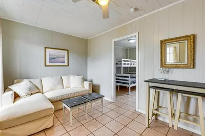 a living room with a couch and a table at Steps to Sand! PCB Haven with Furnished Outdoor Area in Panama City Beach