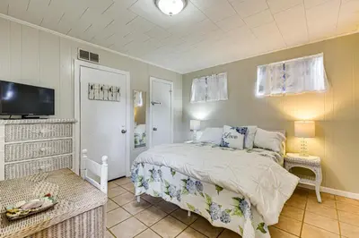 a bedroom with a bed and a flat screen tv at Steps to Sand! PCB Haven with Furnished Outdoor Area in Panama City Beach