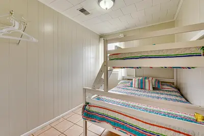 a bunk room with two bunk beds in it at Steps to Sand! PCB Haven with Furnished Outdoor Area in Panama City Beach
