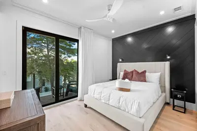 a bedroom with a white bed and a large window at Endless Views 30A in Santa Rosa Beach