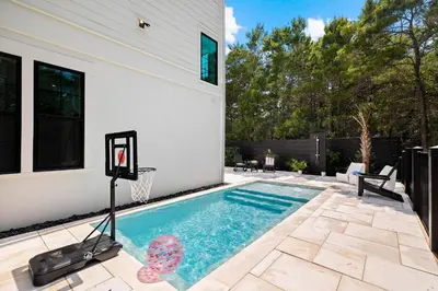 a swimming pool with a basketball hoop in a backyard at Endless Views 30A in Santa Rosa Beach