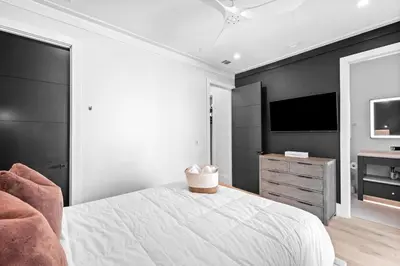 a bedroom with a white bed and a television at Endless Views 30A in Santa Rosa Beach