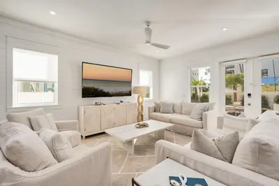 a living room with white furniture and a view of the ocean at Pelayo Solage in Santa Rosa Beach