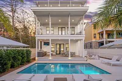 a house with a swimming pool in front of a house at Pelayo Solage in Santa Rosa Beach