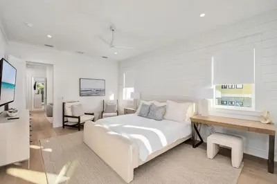 a white bedroom with a bed and a desk at Pelayo Solage in Santa Rosa Beach