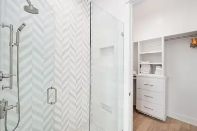a bathroom with a shower with a glass door at Pelayo Solage in Santa Rosa Beach