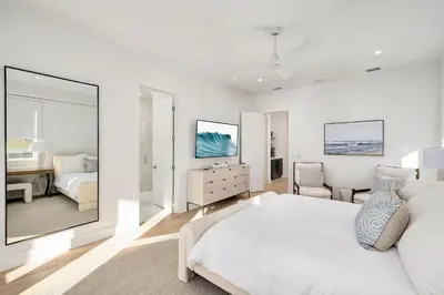 a white bedroom with a bed and a desk at Pelayo Solage in Santa Rosa Beach