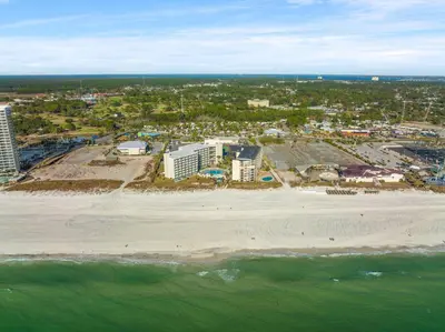 an aerial view of a beach with buildings and the ocean at Beach Front Ocean View Condo - Top of the Gulf 105 in Panama City Beach
