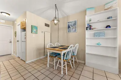 a dining room with a table and chairs at Beach Front Ocean Front Condo Top of the Gulf 516 in Panama City Beach