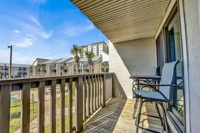 a balcony with two chairs and a table at Largo Dream at Largo Mar in Panama City Beach