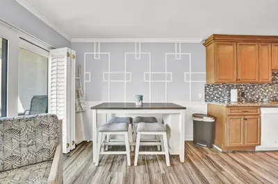 a kitchen with a table and two stools at Largo Dream at Largo Mar in Panama City Beach