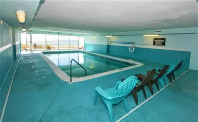 a large swimming pool with chairs in a building at Sugar Sand at Ocean Reef in Panama City Beach