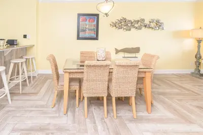 a dining room with a table and chairs at Sugar Sand at Ocean Reef in Panama City Beach