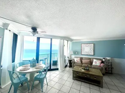 a living room with a couch and a table at Amazing View Beach Front King Bed in Panama City Beach