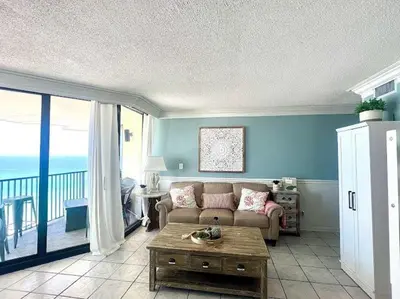 a living room with a couch and a table at Amazing View Beach Front King Bed in Panama City Beach