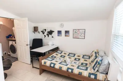 a bedroom with a bed and a desk and a table at Pet Friendly Cheerful home on Emerald Coast - by SharpCat in Panama City