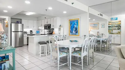a kitchen and dining room with a table and chairs at BeachCrest 1202 in Santa Rosa Beach