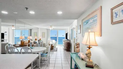 a dining room and living room with the ocean at BeachCrest 1202 in Santa Rosa Beach