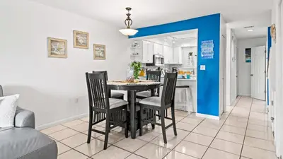a kitchen and dining room with a table and chairs at Portside Resort V4 in Panama City Beach