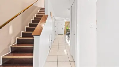 a hallway with stairs in a home with white walls at Portside Resort V4 in Panama City Beach