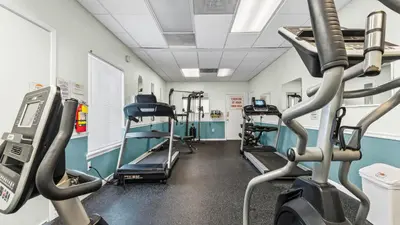 a gym with several treadmills and tread machines at Portside Resort V4 in Panama City Beach