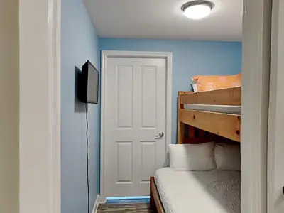 a bedroom with a white door and a bunk bed at Shores of Panama #1707 in Panama City Beach
