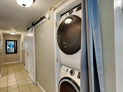 a laundry room with a washer and dryer at Shores of Panama #1707 in Panama City Beach