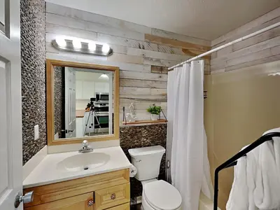 a bathroom with a toilet and a sink and a mirror at Stay Salty in Panama City Beach