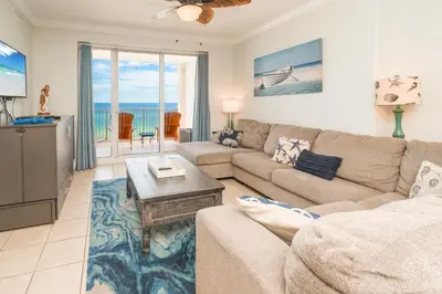 a living room with a couch and a table at The Sandy Pearl at Ocean Reef in Panama City Beach