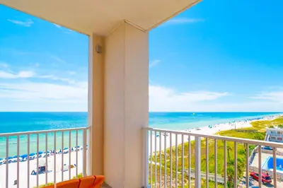 a balcony with a view of the beach and the ocean at The Sandy Pearl at Ocean Reef in Panama City Beach