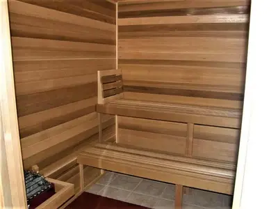 a sauna with wooden walls and wooden shelves at Blue Horizon at Ocean Reef in Panama City Beach
