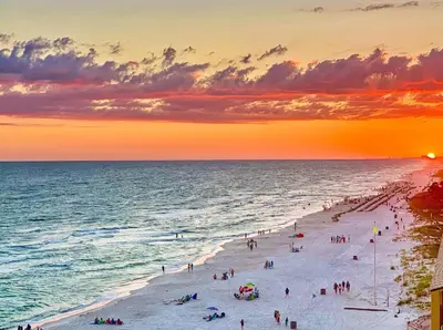 a group of people on a beach at sunset at Blue Horizon at Ocean Reef in Panama City Beach