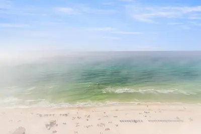 an overhead view of a beach with people and the ocean at Pelicans Point South at Shores in Panama City Beach