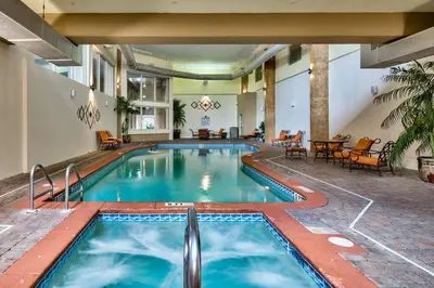 a pool at a hotel with chairs and a table at Pelicans Point South at Shores in Panama City Beach