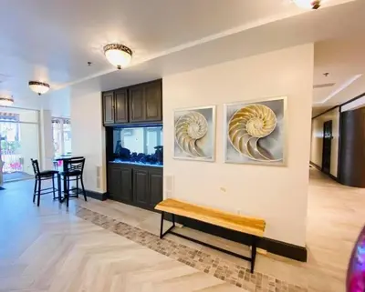 a living room with a bench and paintings on the wall at Pelicans Point South at Shores in Panama City Beach