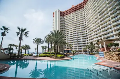 a large swimming pool in front of a large building at Pelicans Point South at Shores in Panama City Beach