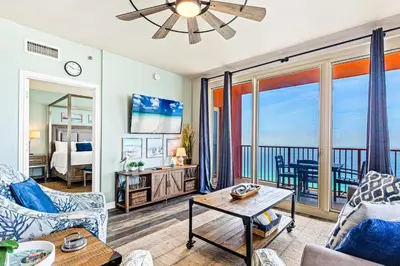 a living room with a view of the ocean at Pelicans Point South at Shores in Panama City Beach