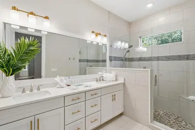 a white bathroom with a sink and a mirror at Family Coastal Escape in Inlet Beach