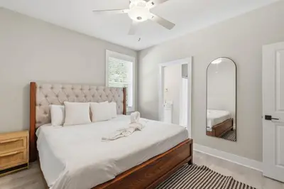 a bedroom with a large bed and a mirror at Family Coastal Escape in Inlet Beach